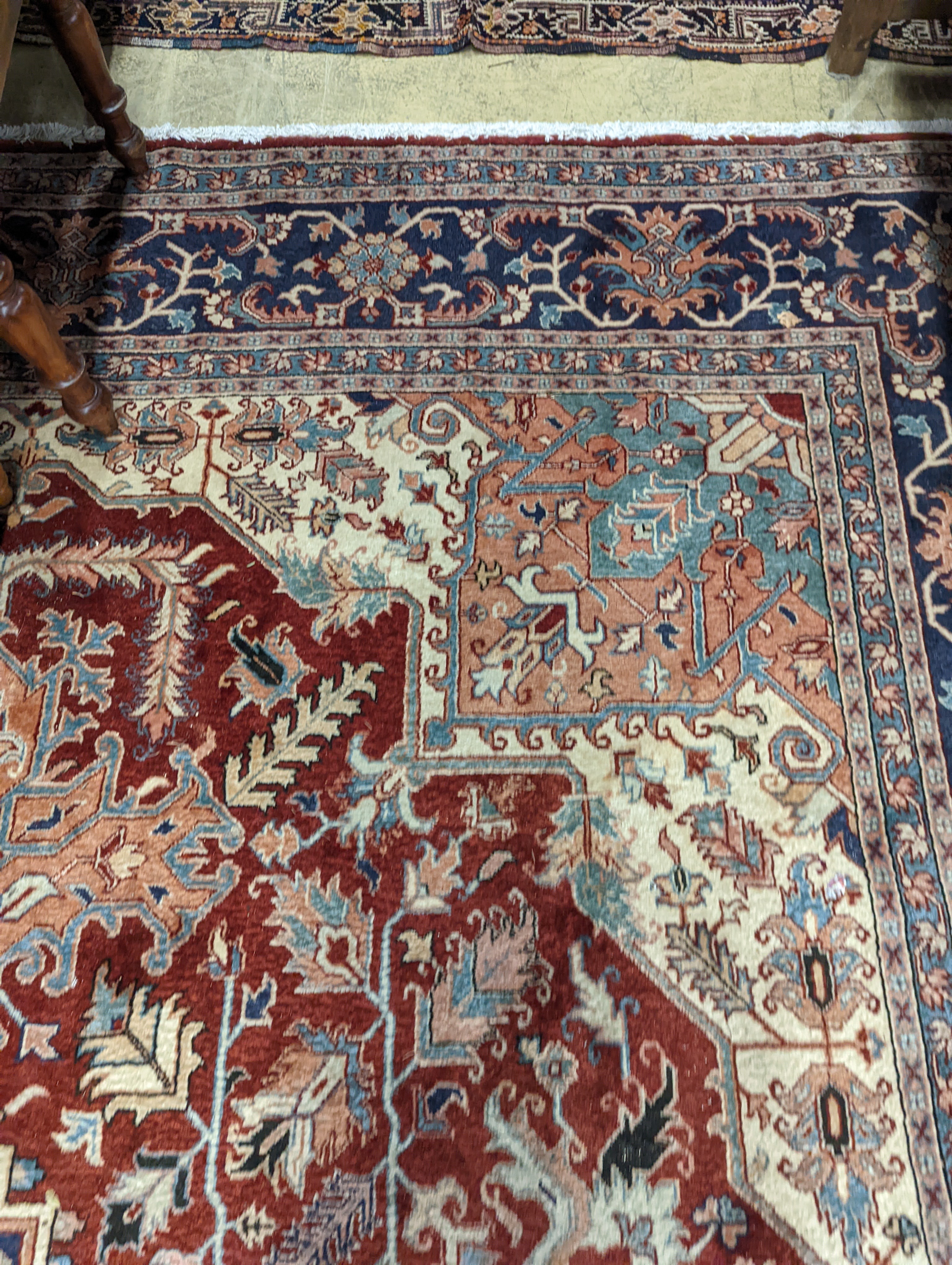 A large Caucasian style red ground carpet, 460 x 330cm